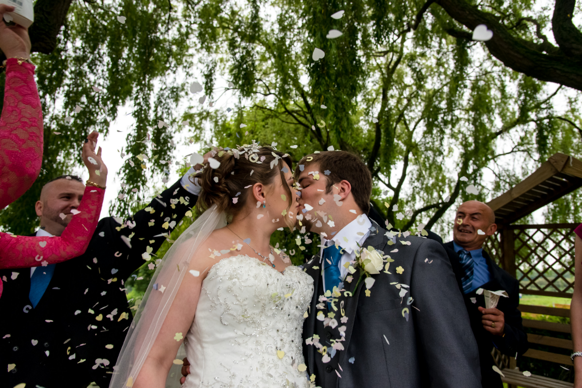 wedding venue leeds wakefield bride and groom kissing in confetti.